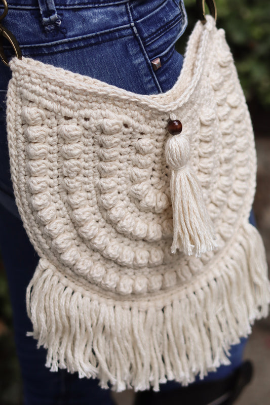 white crochet handbag with boho tassel fringe and tassel bead detail.